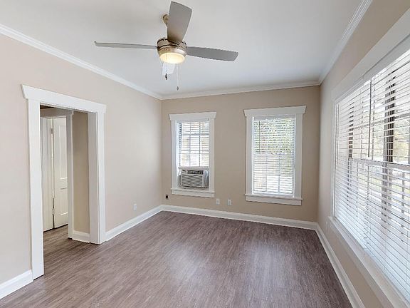 Studio living area with ceiling fan and air conditioner