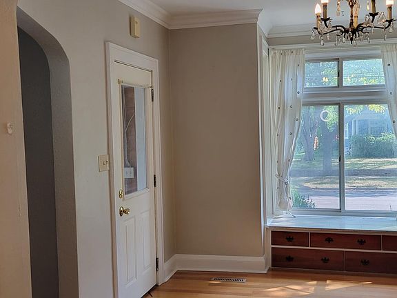 Dining room with bay window and main entrance.