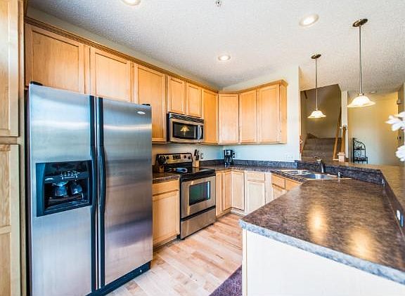 Large kitchen with stainless appliances.