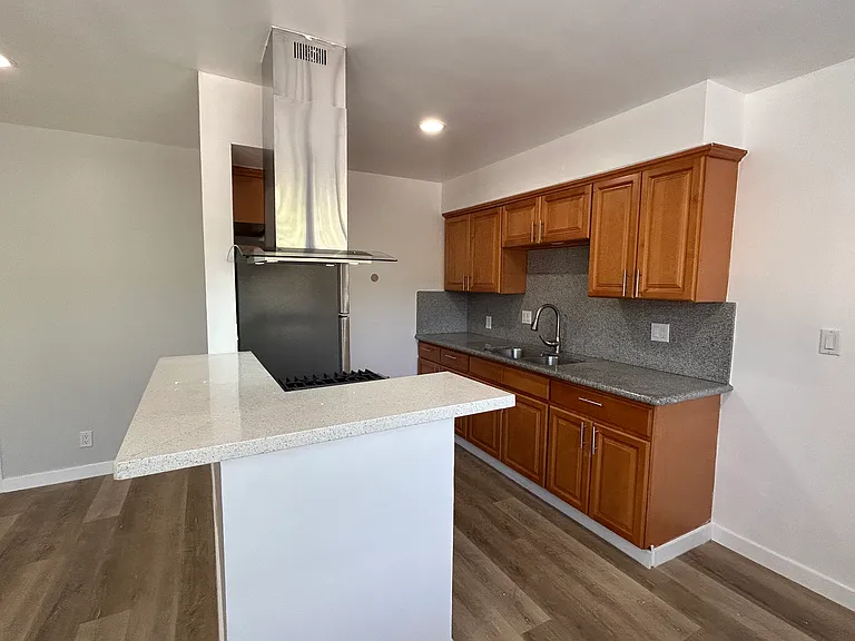 Kitchen with wooden cabinets and granite counter tops.