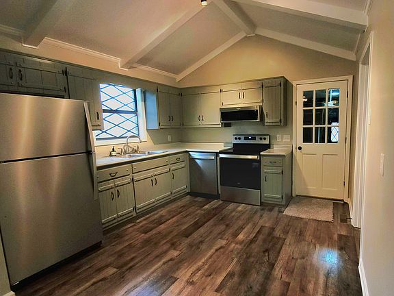 The kitchen has all stainless steel appliances, range, microwave, dishwasher, and refrigerator.