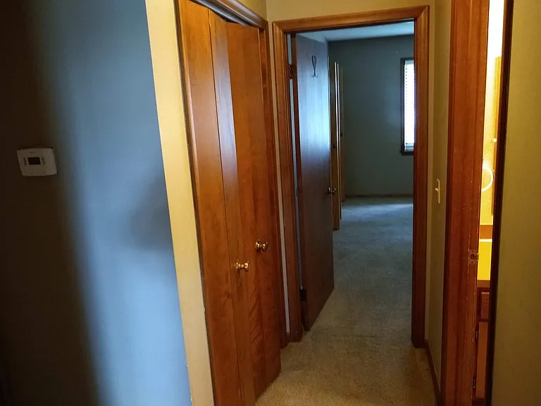 Linen closet between bedrooms opposite bathroom and connecting front and back bedrooms.
