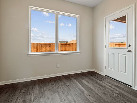 The adjoining dining room is spacious and inviting with a view of the backyard.