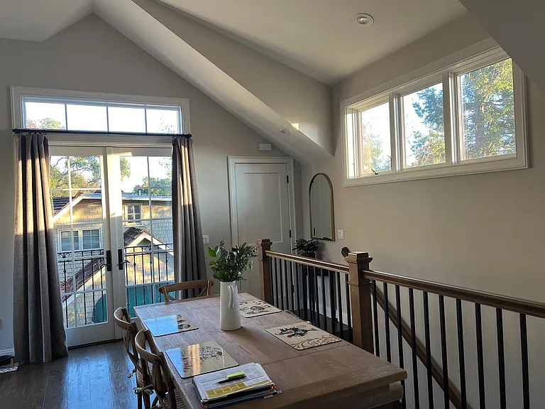 Dining area high windows bring in the morning light.