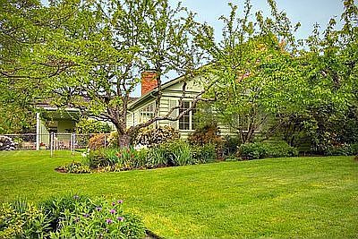 Gorgeous setting with mature landscaping and fruit trees