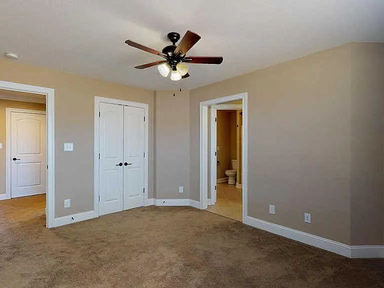 Bright upstairs bedroom connected shared access to jack and Jill bathroom, includes individual sink and vanity space.