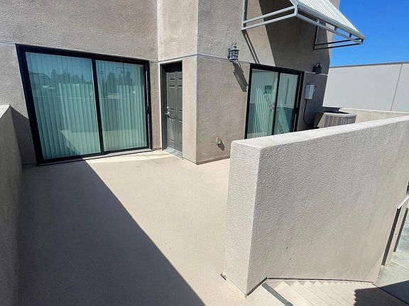 Patio Front door, stairway up to apartment