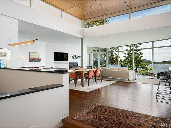 Large foyer invites and welcomes with polished concrete radiant floors adjacent powder room.