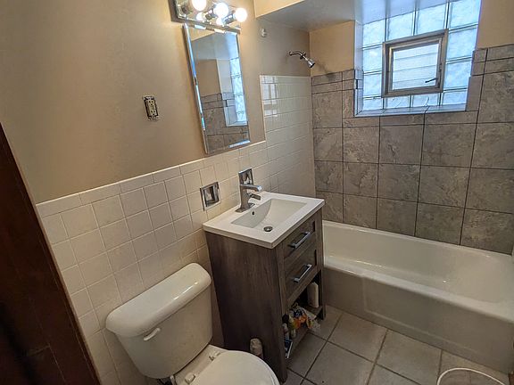 Bathroom with updated vanity and new tile in the shower