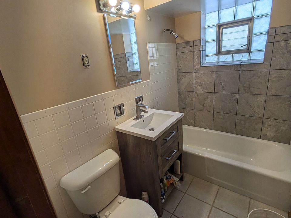 Bathroom with updated vanity and new tile in the shower