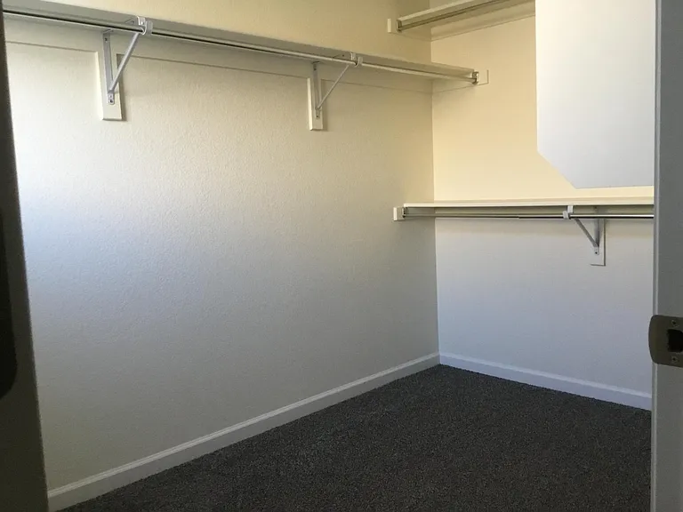 Main suite spacious walk in closet with multiple shelves, hooks