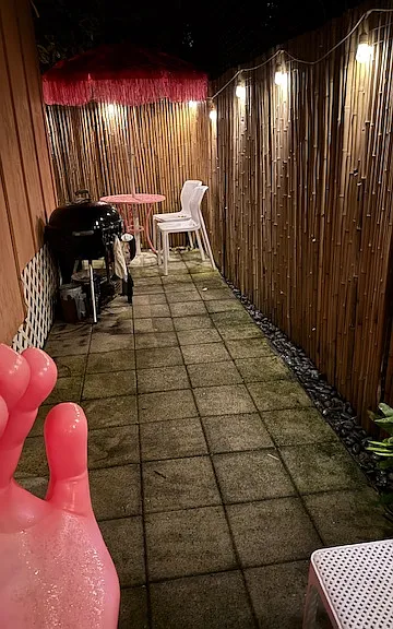 outside, it's raining but at the back of the property. Also there is a fun pink fingers chair. Maybe I can shot a better picture