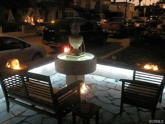 Illuminated fountain and wall of the front patio at night