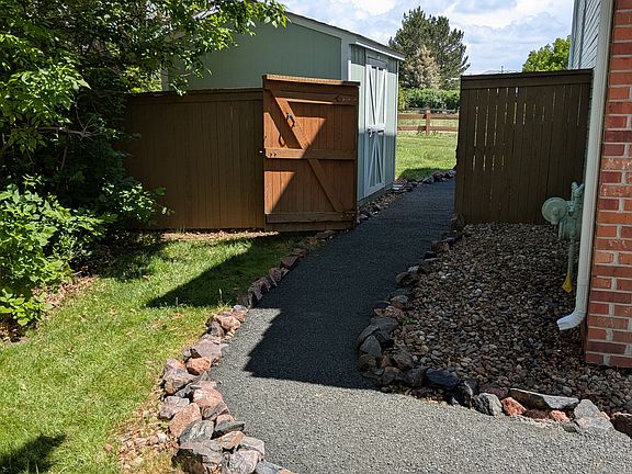 Left of garage showing shed in backyard