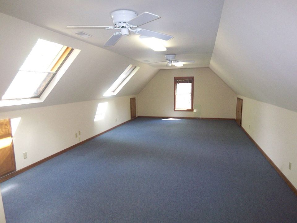 Huge bonus room has kneehole storage and private staircase to 3-car garage