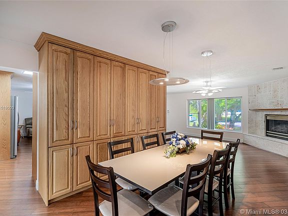 Dining room with custom cabinets and view of fireplace.