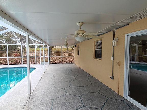 Large covered patio with ceiling fans and lights