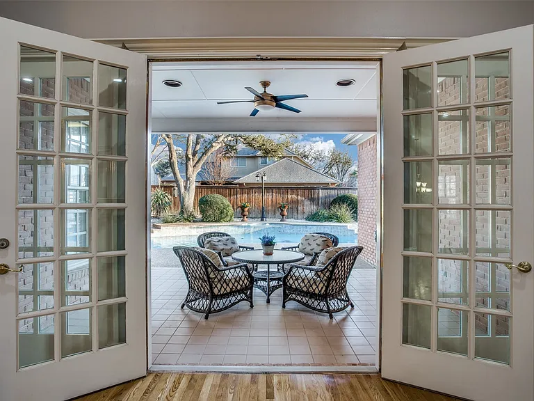 The French doors open to a little piece of paradise! A large coved patio and a sparkling patio, with a water feature, is perfect for any time of year.