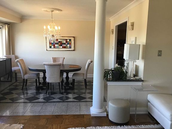 View from living room into dining room featuring polished stone floors