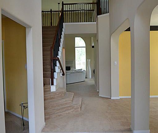 Stunning entry with iron railing on stairway.