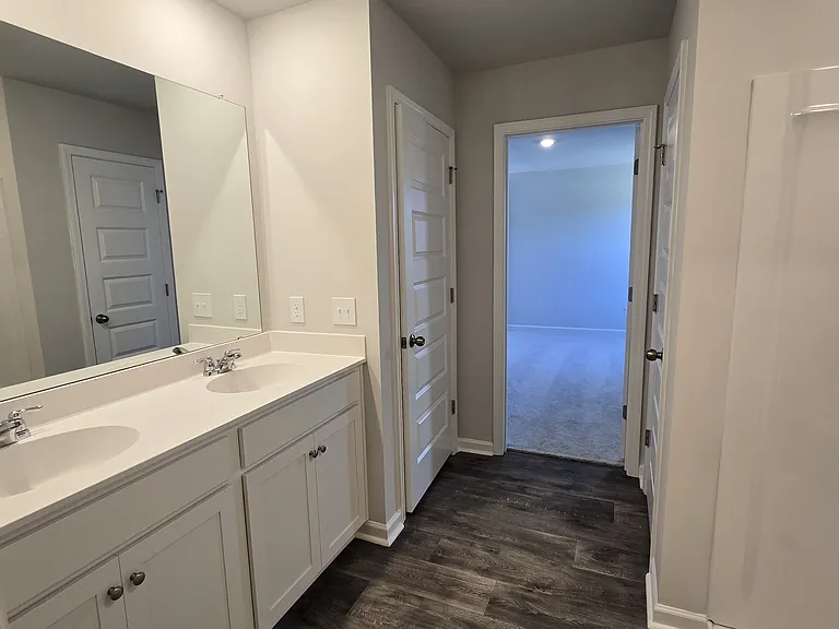 Primary bath with 2 sinks, water closet and storage