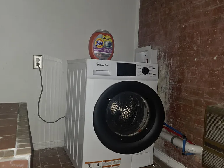 Private laundry room with a all in one washer and dryer.