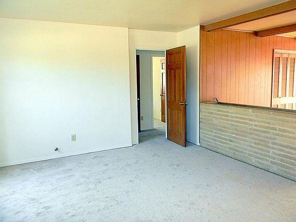 Formal dining room adjacent to living room making it easier to entertain. It is spacious and complete with clean, neutral paint & carpet.