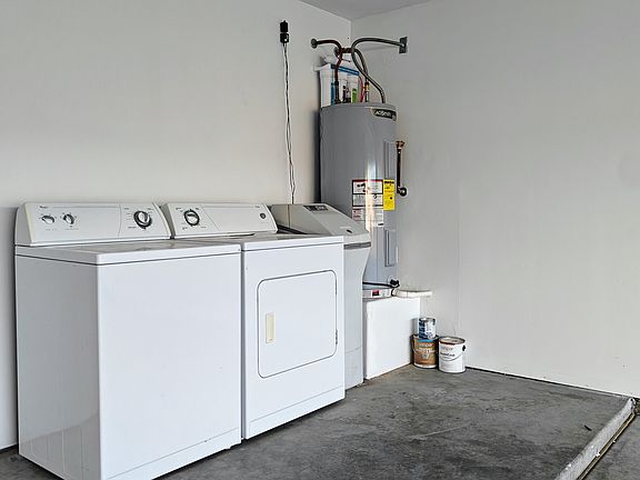 Utility corner of the garage with washer and dryer, water softener, reverse osmosis, and water heater