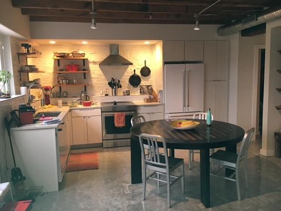 Kitchen and dining . Wood shelves from salvaged lumber
