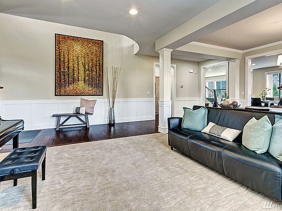 Cozy formal living room with wainscoting wood panels & pillars
