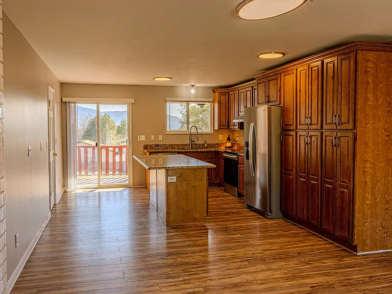 Kitchen and dining with sliding door leading to a large deck