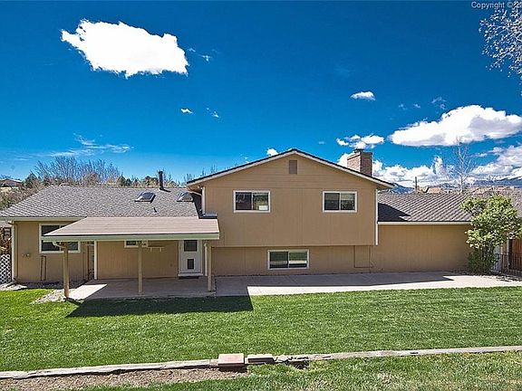 Back of the home with both covered and uncovered patio