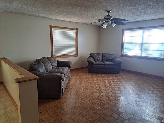Large entertainment room with wood floor.