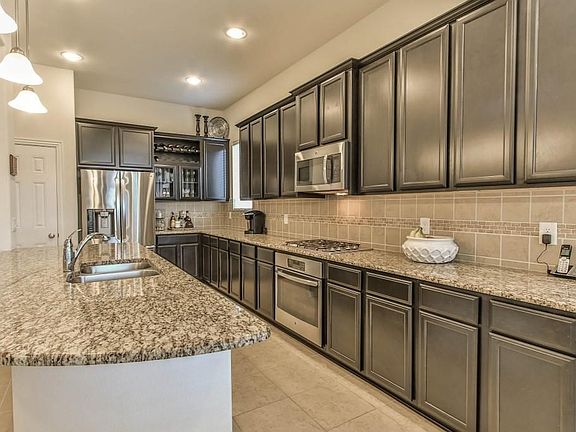 Island Kitchen with granite countertops, SS appliances, custom wine rack