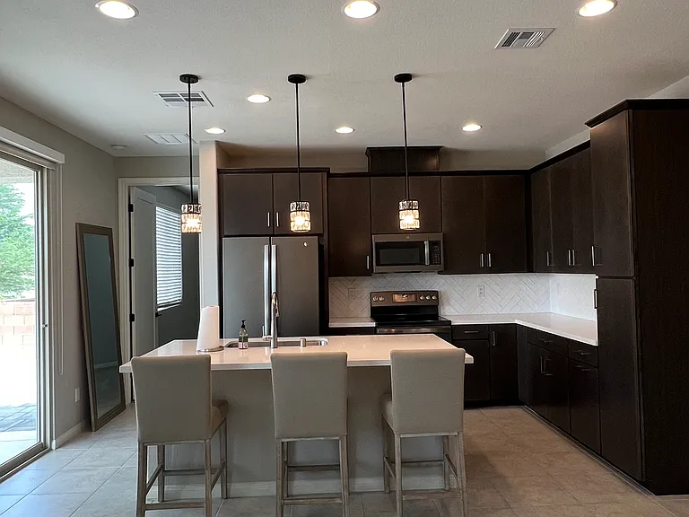 Modern kitchen featuring a center island, stainless-steel appliances, and cabinet space