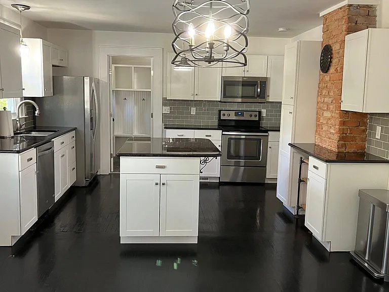 Drenched in natural sunlight are your dining area and large kitchen, full of storage.