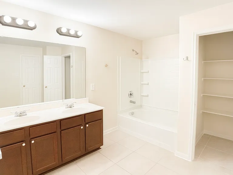Master bathroom with a towel pantry