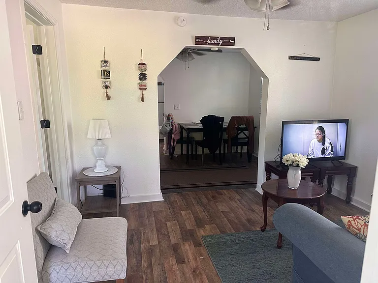 Front door entry to cozy living room and through arch is eat-in dining area