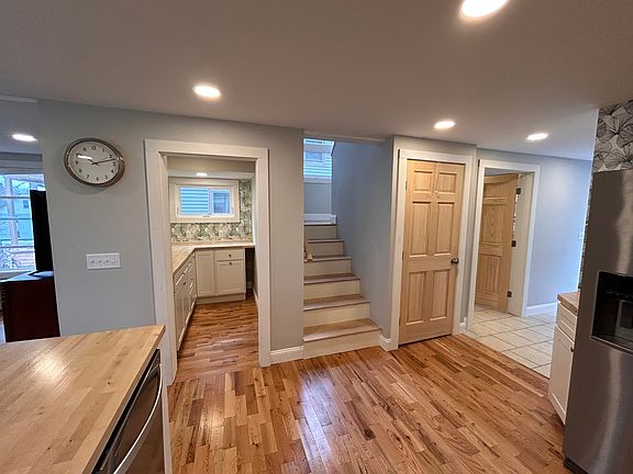 View of kitchen into butlers pantry and stairway.