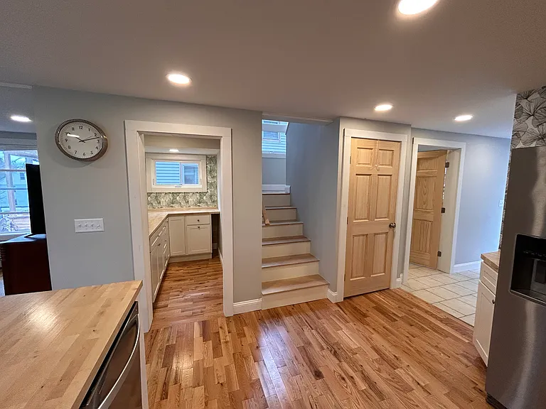 View of kitchen into butlers pantry and stairway.