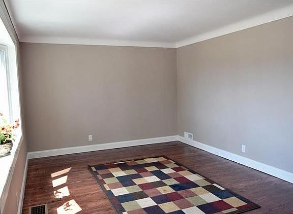 Beautiful hardwood floors and the bay window warm this inviting living room.