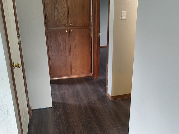 Hallway going to the restroom and bedrooms with a coat closet and linen pantry