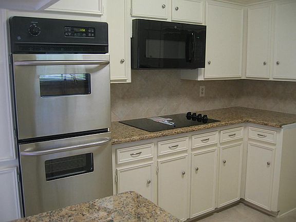 New granite, double oven, range, microwave