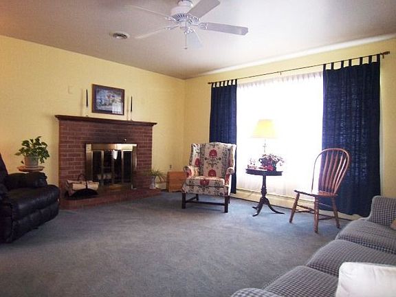 Spacious living room features brick fireplace 