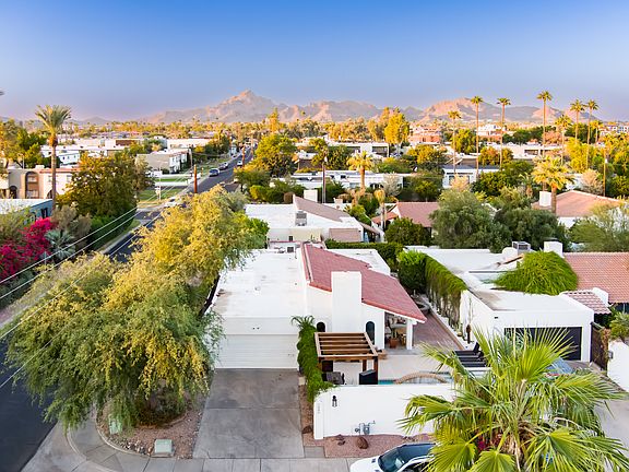 Drone view of house and Camelback Mountain in the distance.