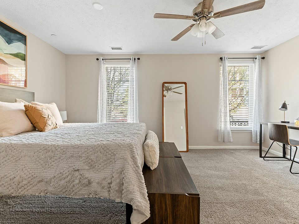 Enjoy a spacious bedroom with natural light and a ceiling fan for ultimate comfort in downtown Akron