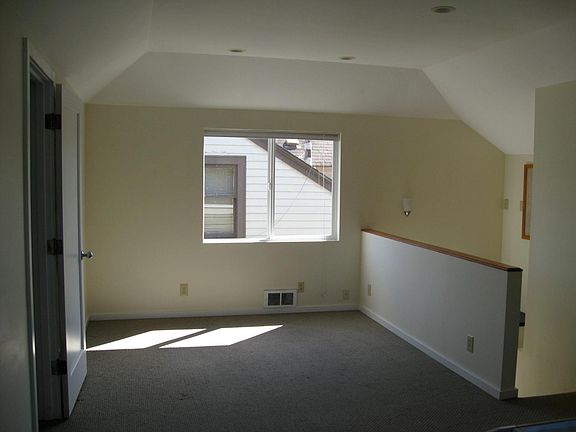 The living room, the stairs to the front door are at the right.
