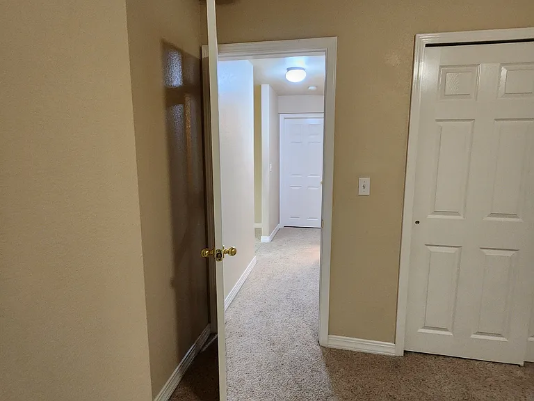Downstairs Bedroom #2, looking down the hallway to Bedroom #1. The Downstairs Bathroom is located between the bedrooms.