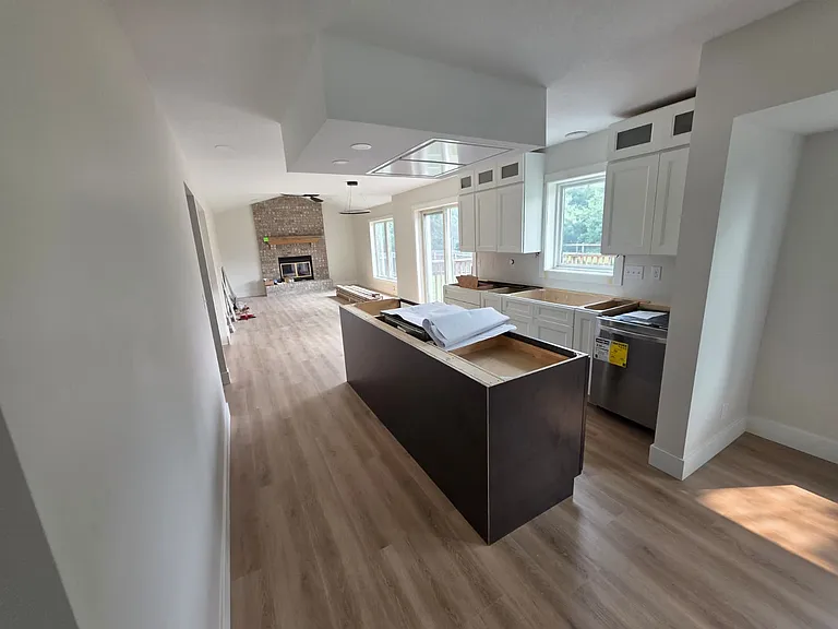 Kitchen, informal dining space, and fireplace room. Premium vinyl planking throughout the home. Kitchen with under cabinet lighting. Great cooks kitchen with dual fuel (gas and electric) range. Everything is brand new.