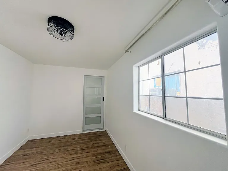 Bedroom, with door to bathroom ahead.